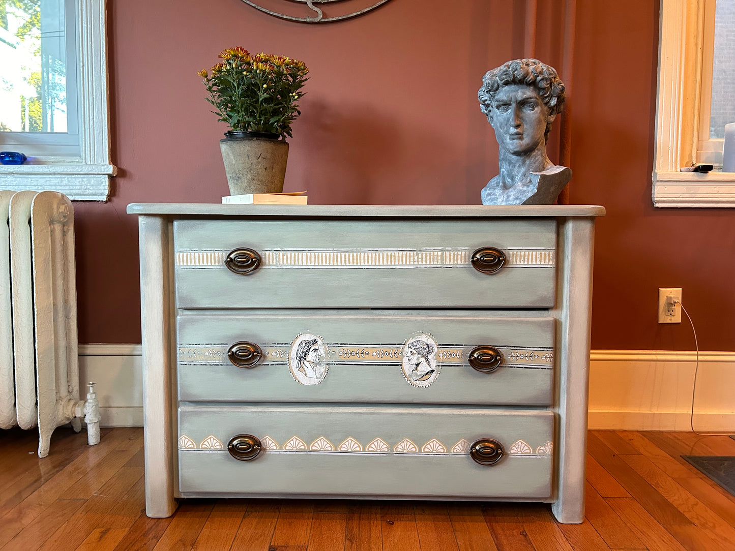 Solid pine chest of drawers in Annie Sloan Coolabah Green, Country Gray and French Linen Chalk Paint®, selected patterns from the “Classical Cameos” IOD/AS inlay,  matte lacquer